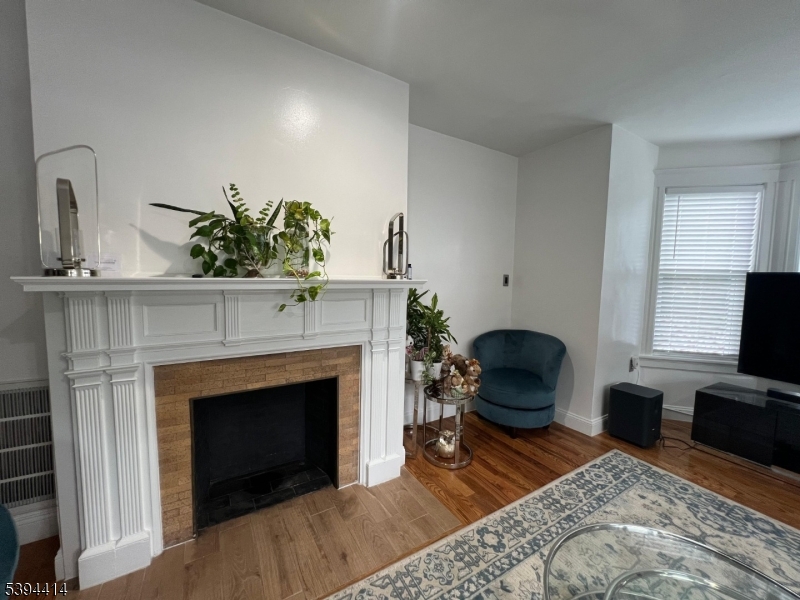 865 Westfield Avenue Elizabeth, NJ 07208 - Photo 12 of 26 a living room with furniture and a fireplace