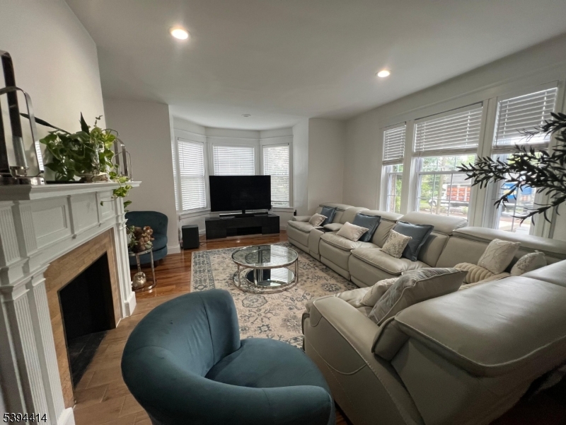 865 Westfield Avenue Elizabeth, NJ 07208 - Photo 14 of 26 a living room with furniture a fireplace and a flat screen tv