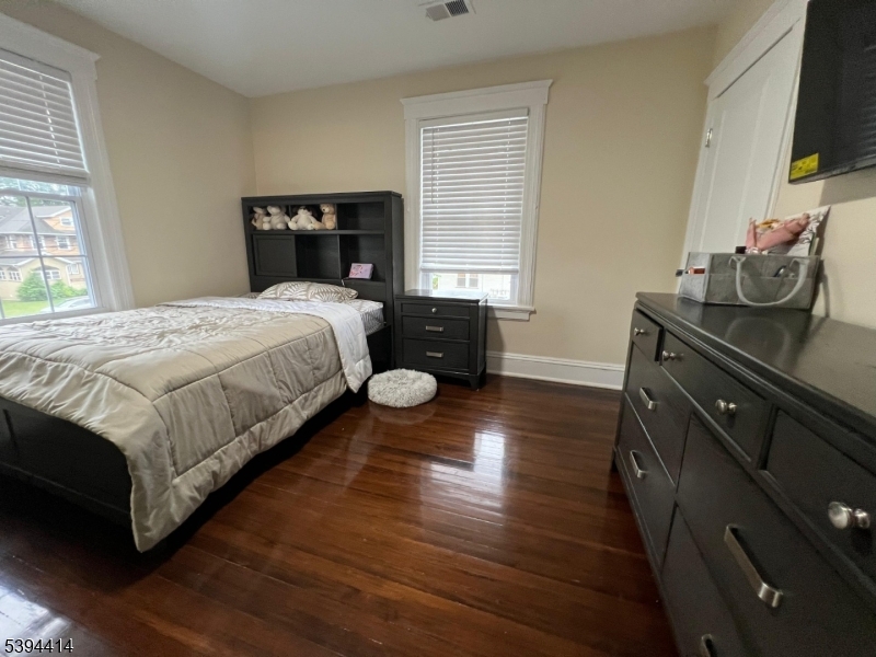 865 Westfield Avenue Elizabeth, NJ 07208 - Photo 24 of 26 a bedroom with a bed and flat tv screen on a dresser