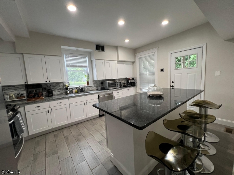 865 Westfield Avenue Elizabeth, NJ 07208 - Photo 26 of 26 a kitchen with stainless steel appliances granite countertop a sink a stove a table and chairs