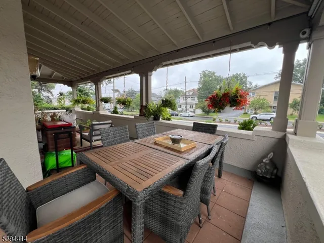 a view of a patio with table and chairs and potted plants