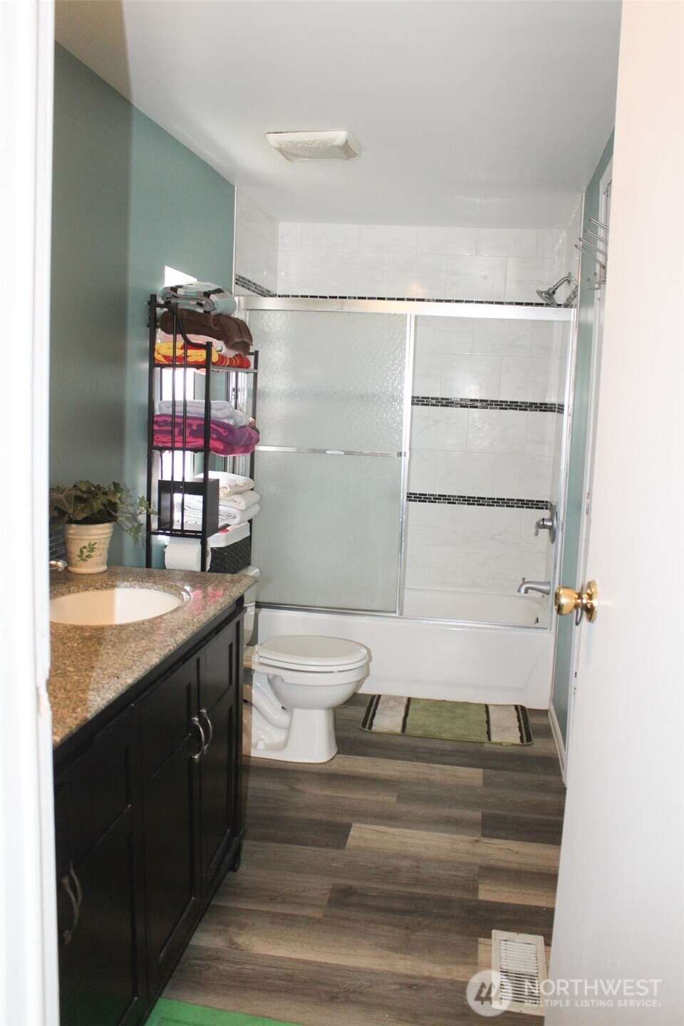 5705 Littlerock Road Southwest, Unit 41 Tumwater, WA 98512 - Photo 13 of 18 a bathroom with a granite countertop sink a toilet and shower