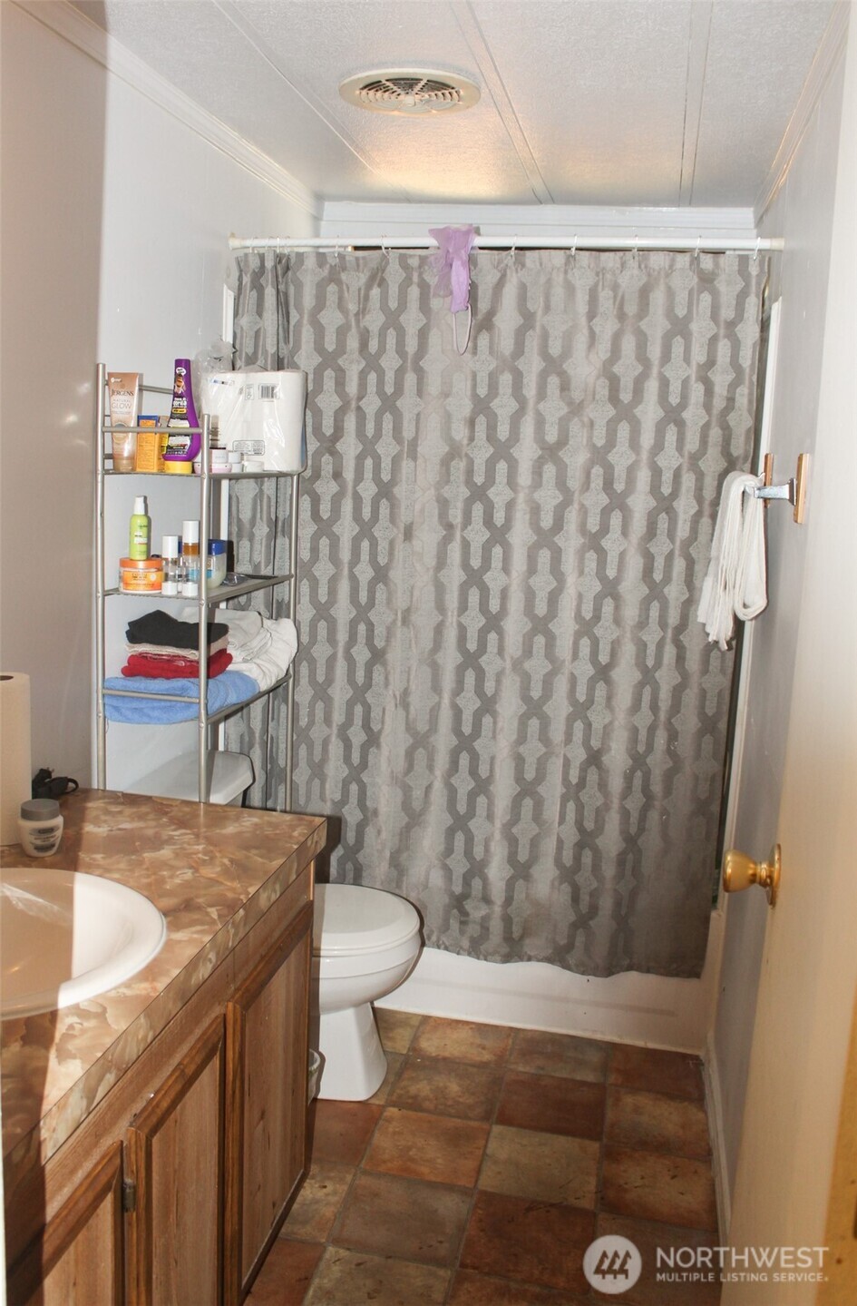 5705 Littlerock Road Southwest, Unit 41 Tumwater, WA 98512 - Photo 16 of 18 a bathroom with a granite countertop sink and a toilet