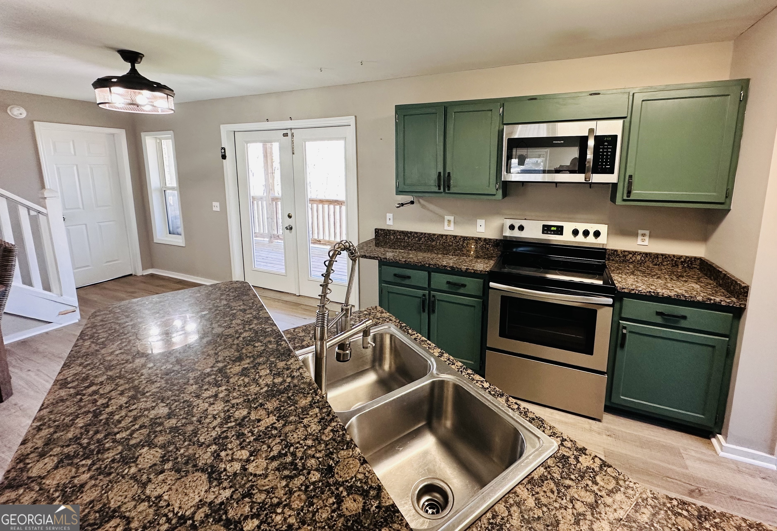 1947 Ivy Mountain Road Clarkesville, GA 30523 - Photo 7 of 31 a kitchen with granite countertop a stove and a sink