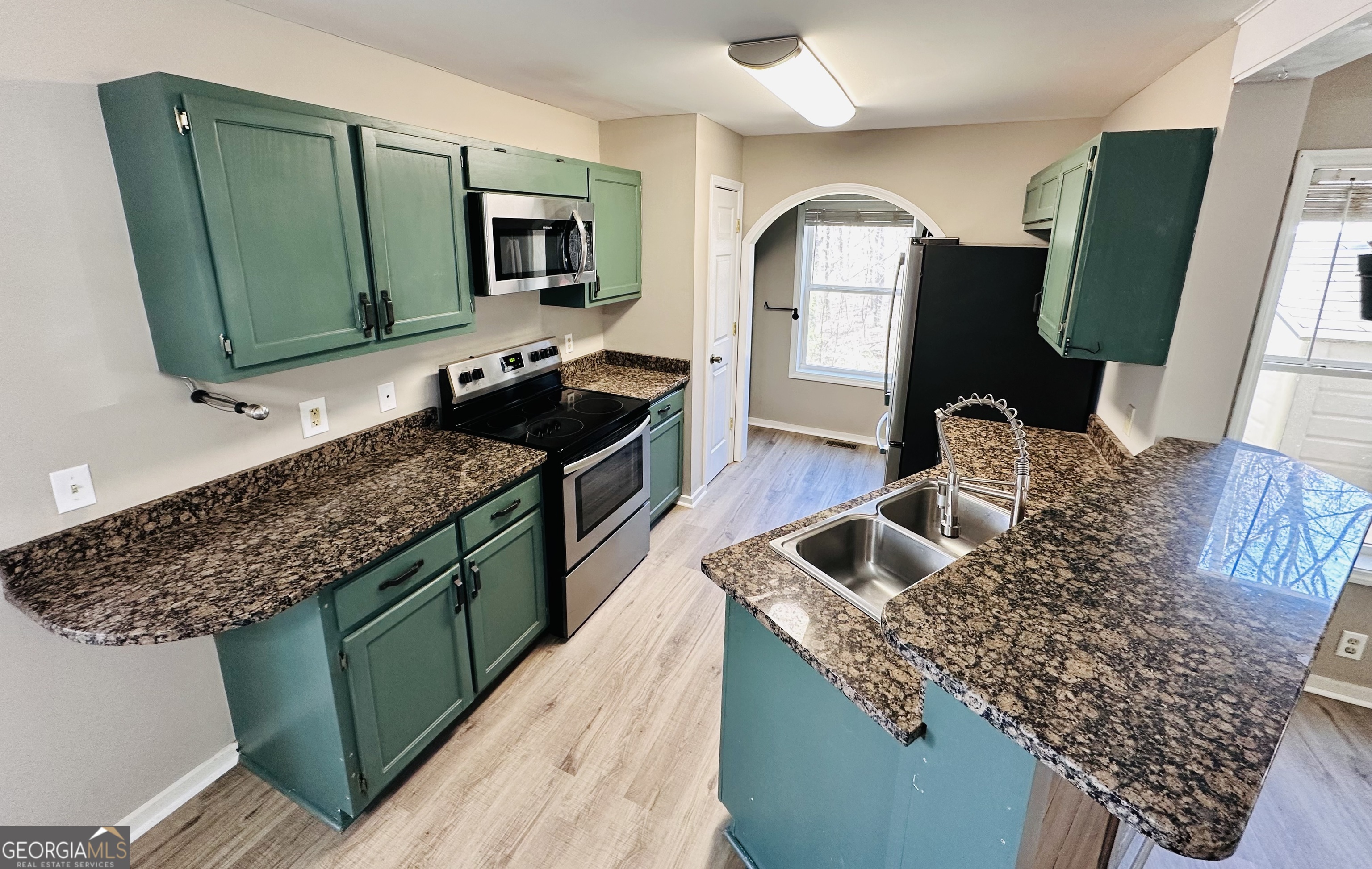1947 Ivy Mountain Road Clarkesville, GA 30523 - Photo 8 of 31 a kitchen with granite countertop a sink a counter top space and cabinets