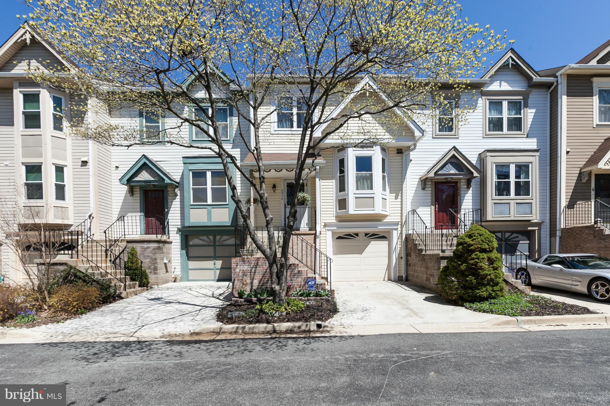 2846 Schoolhouse Circle Silver Spring, MD 20902 - Photo 2 of 28 a front view of a house with a yard and garage