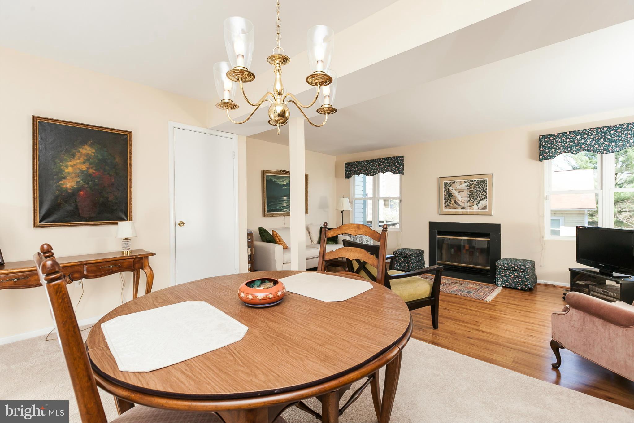 2846 Schoolhouse Circle Silver Spring, MD 20902 - Photo 11 of 28 a view of a dining room with furniture a chandelier and wooden floor