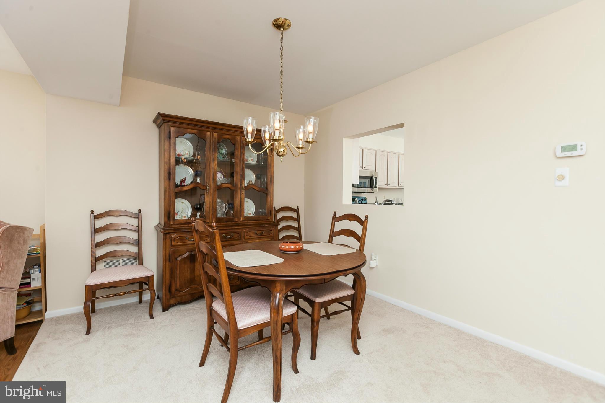 2846 Schoolhouse Circle Silver Spring, MD 20902 - Photo 12 of 28 a view of a dining room with furniture and chandelier