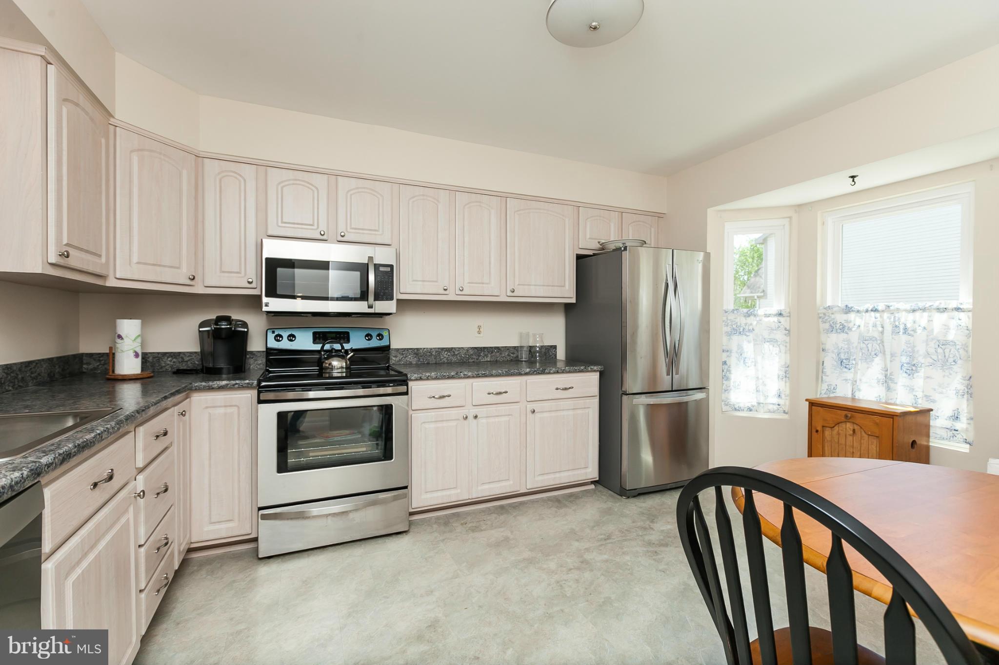 2846 Schoolhouse Circle Silver Spring, MD 20902 - Photo 3 of 28 a kitchen with stainless steel appliances granite countertop a refrigerator sink and stove