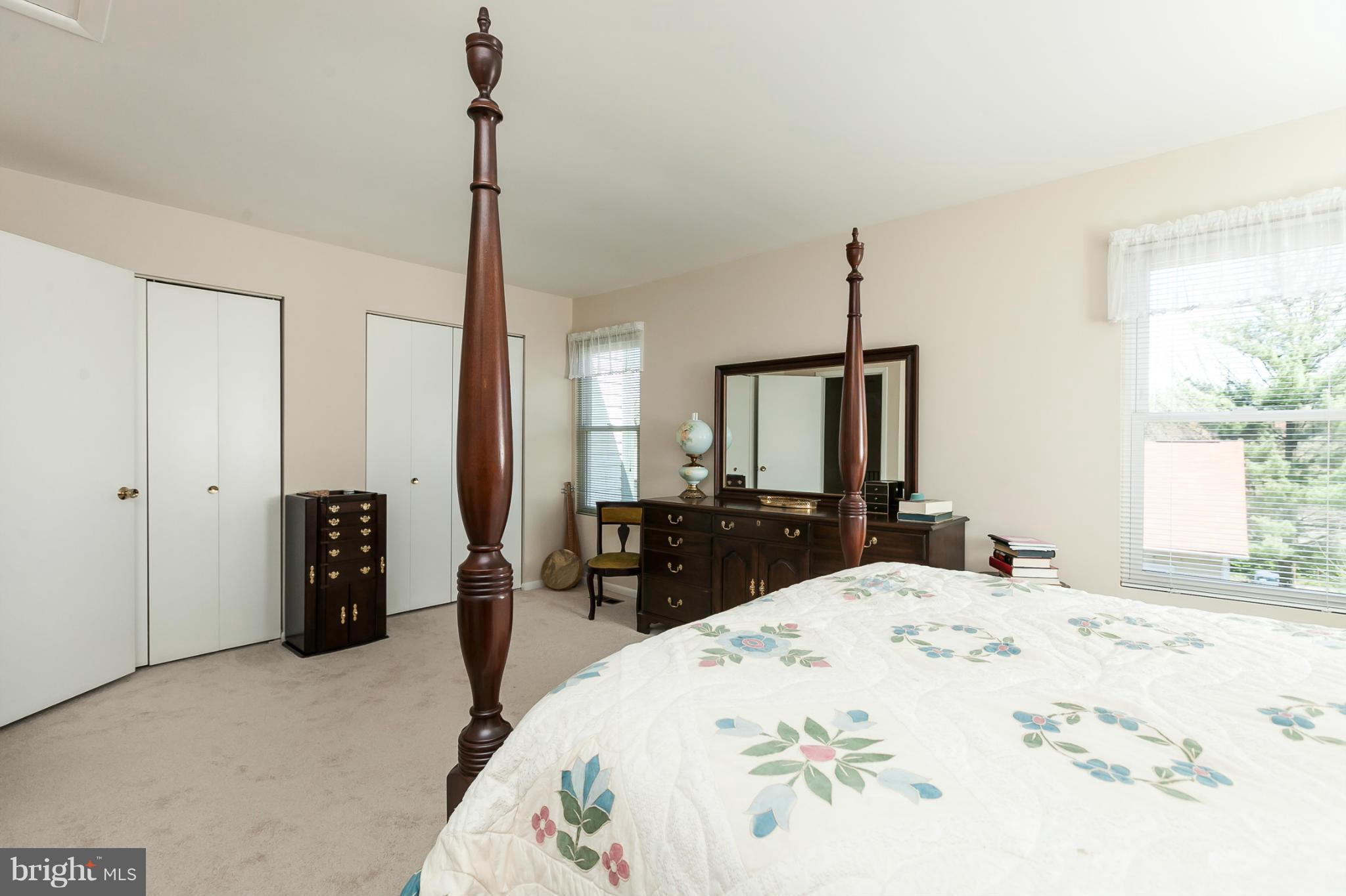 2846 Schoolhouse Circle Silver Spring, MD 20902 - Photo 21 of 28 a large bedroom with a bed and a view of bathroom