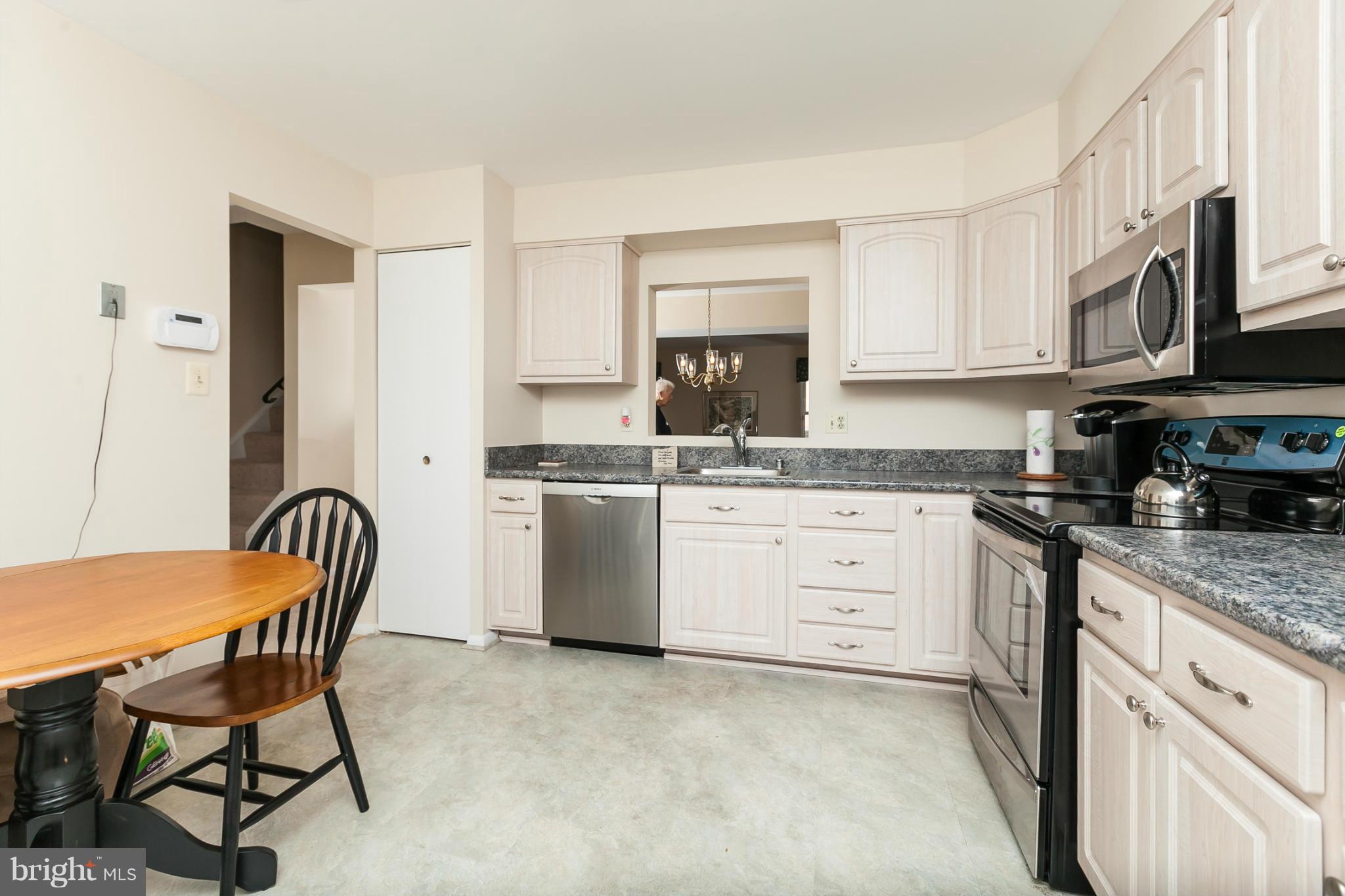 2846 Schoolhouse Circle Silver Spring, MD 20902 - Photo 4 of 28 a kitchen with stainless steel appliances granite countertop a white cabinets a sink stove and a refrigerator