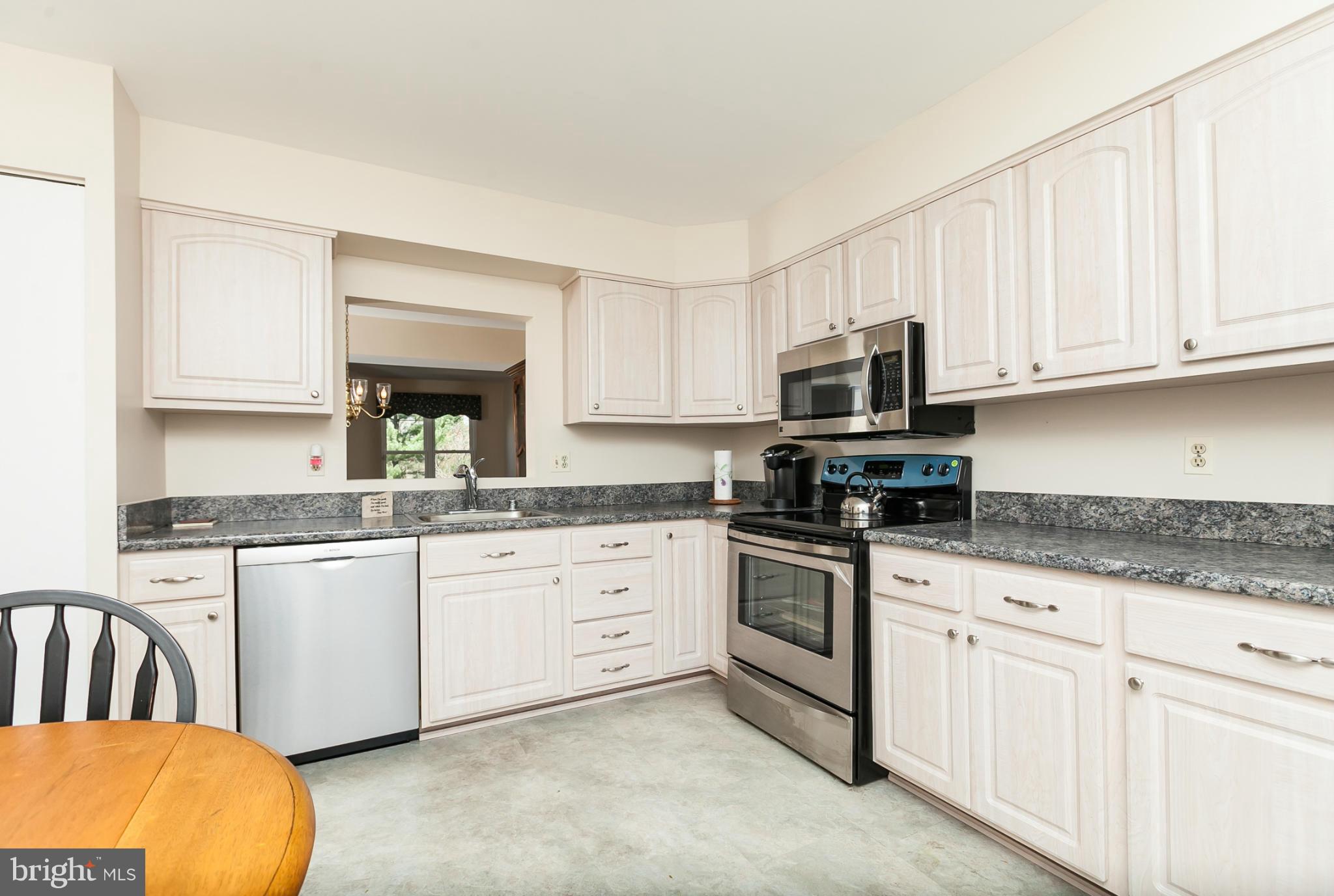 2846 Schoolhouse Circle Silver Spring, MD 20902 - Photo 5 of 28 a kitchen with granite countertop white cabinets white stainless steel appliances and a sink
