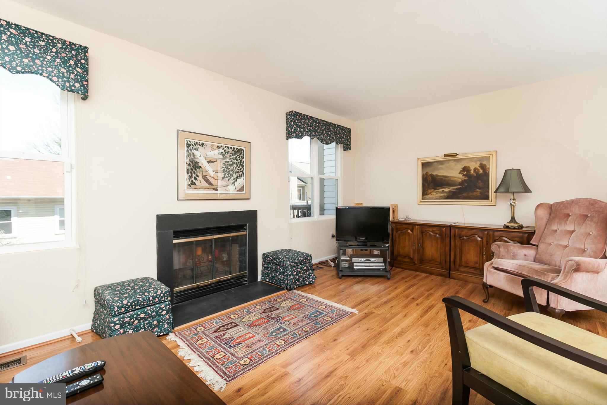 2846 Schoolhouse Circle Silver Spring, MD 20902 - Photo 8 of 28 a living room with furniture a flat screen tv and a fireplace