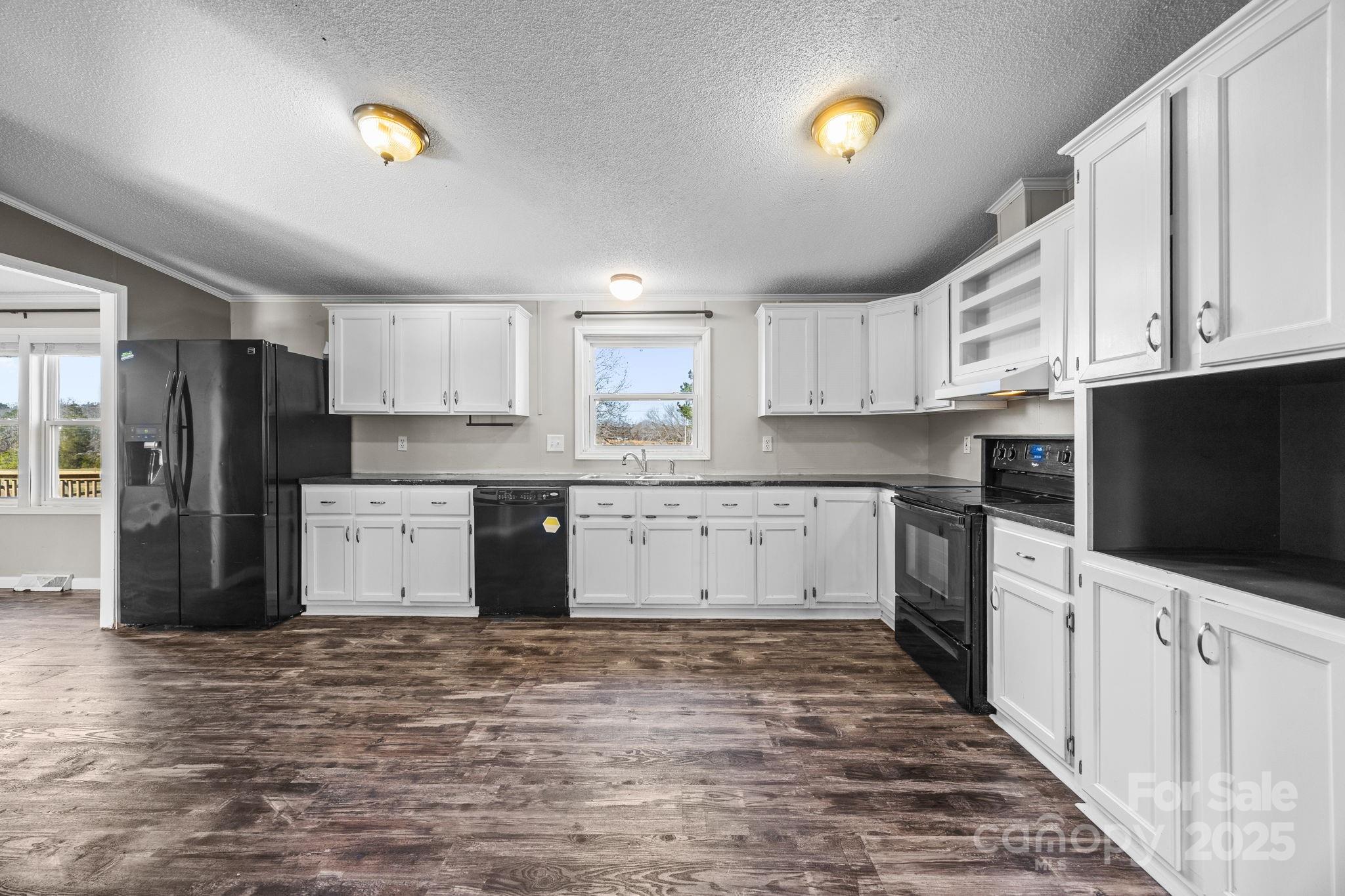 21465 Old Beatty Ford Road Richfield, NC 28137 - Photo 12 of 41 a kitchen with stainless steel appliances kitchen island granite countertop a stove a sink and a refrigerator