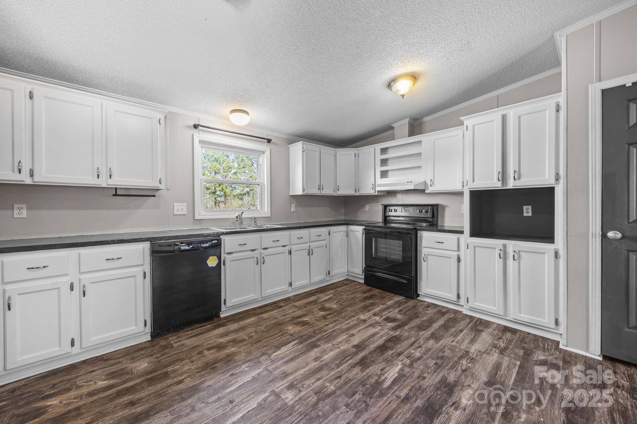 21465 Old Beatty Ford Road Richfield, NC 28137 - Photo 14 of 41 a kitchen with granite countertop a refrigerator sink and cabinets