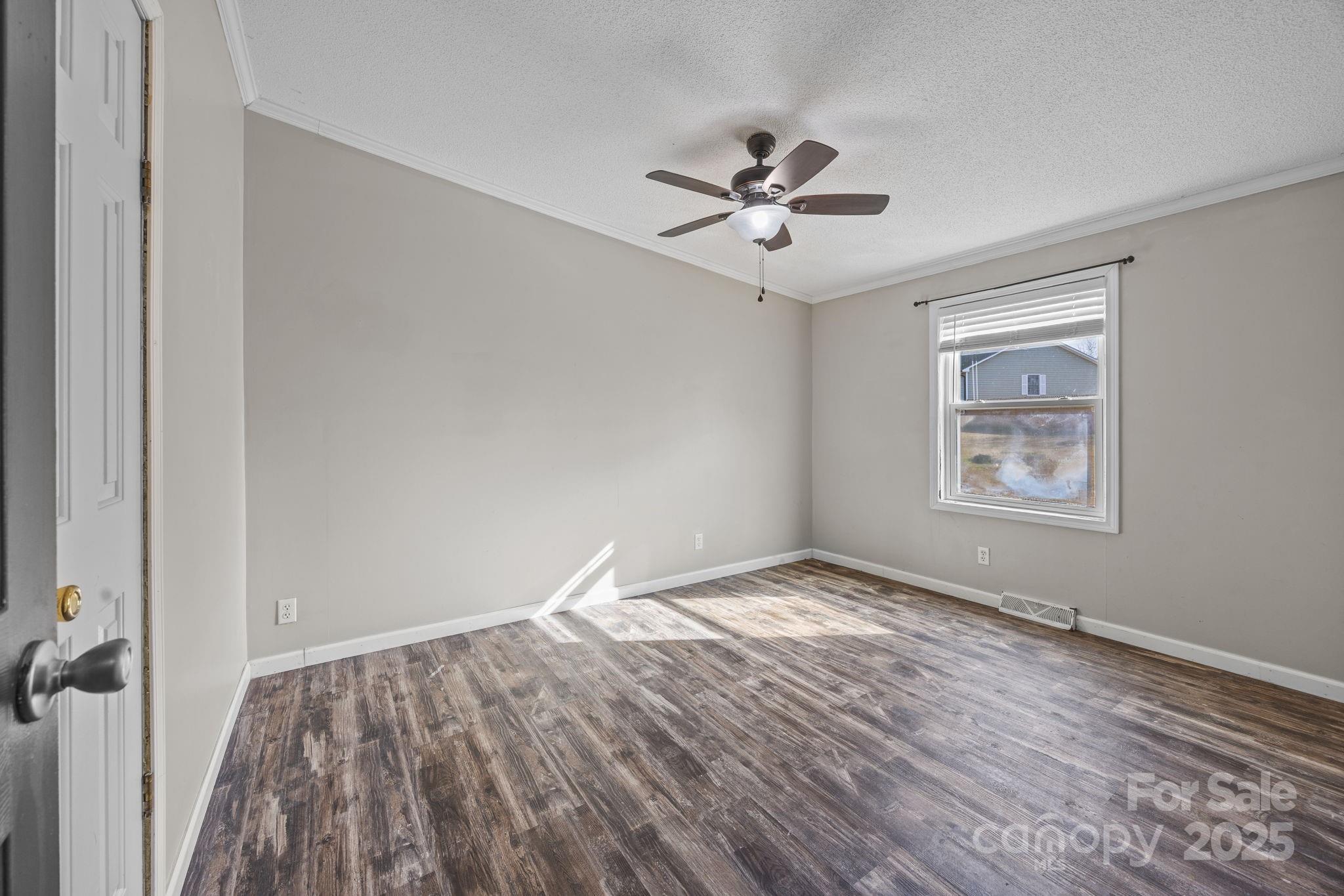 21465 Old Beatty Ford Road Richfield, NC 28137 - Photo 17 of 41 a view of room with window ceiling fan and hardwood floor