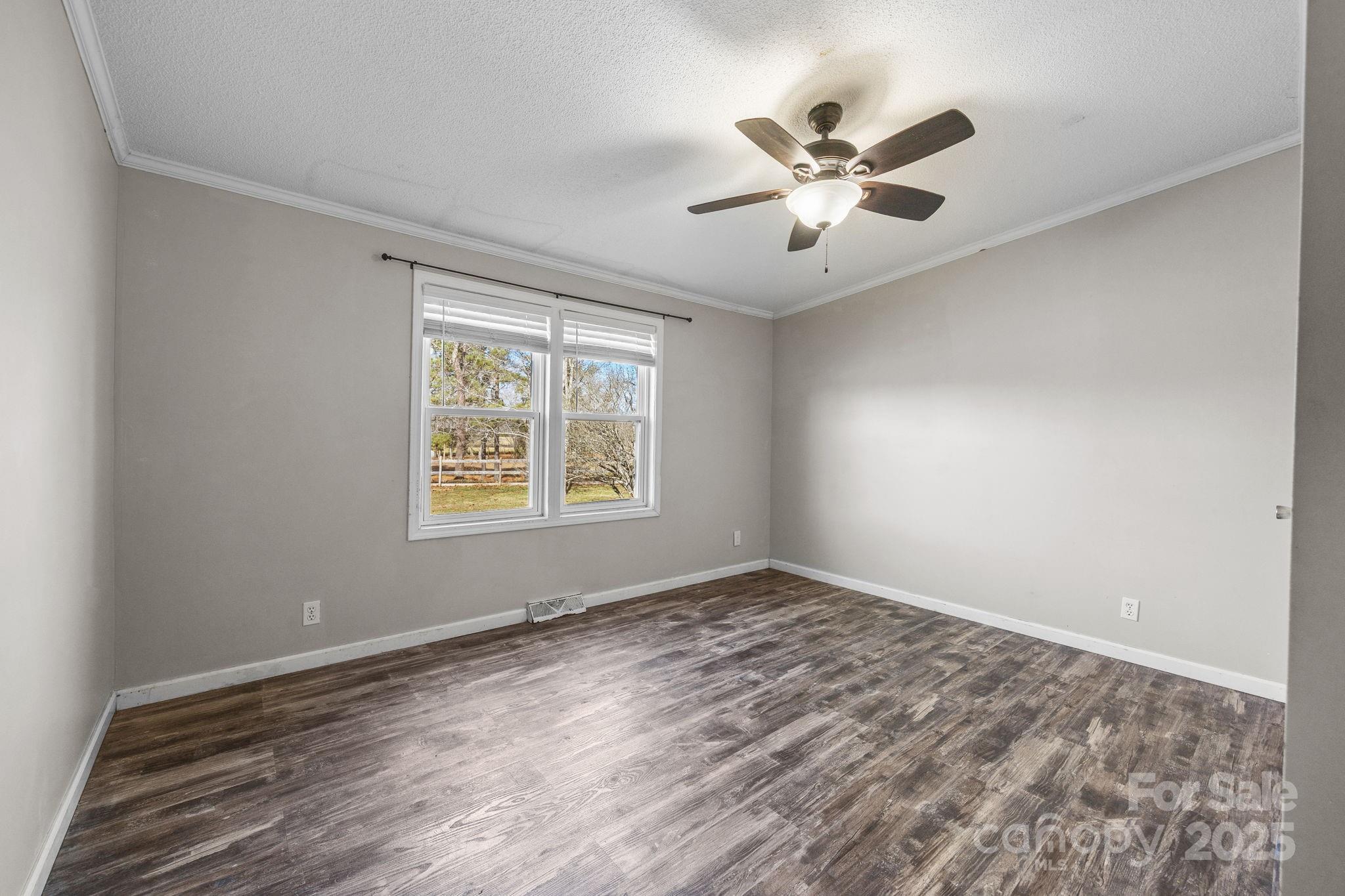 21465 Old Beatty Ford Road Richfield, NC 28137 - Photo 19 of 41 wooden floor in an empty room with a window