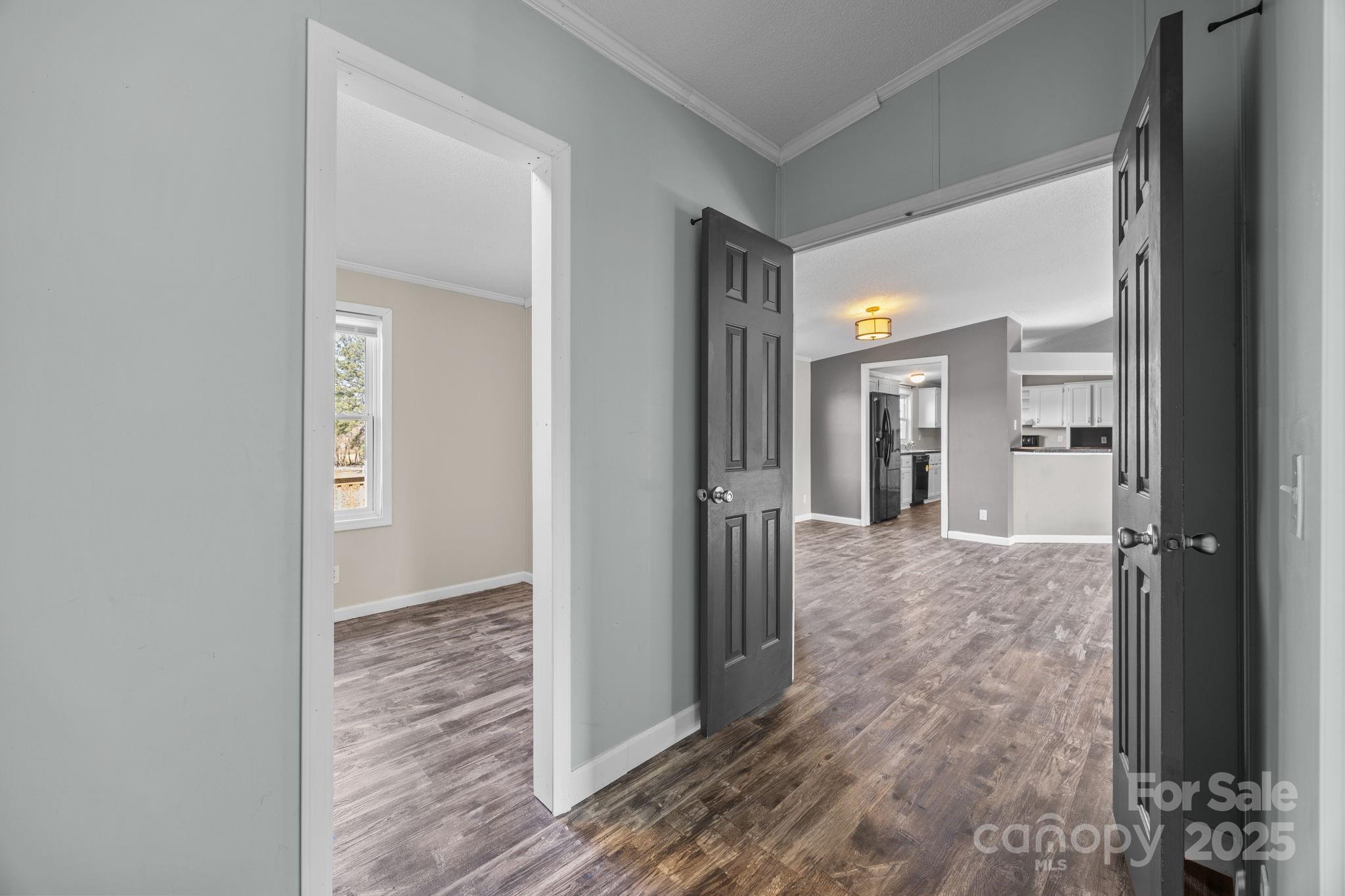 21465 Old Beatty Ford Road Richfield, NC 28137 - Photo 25 of 41 a view of a hallway with a livingroom and a hall with wooden floor
