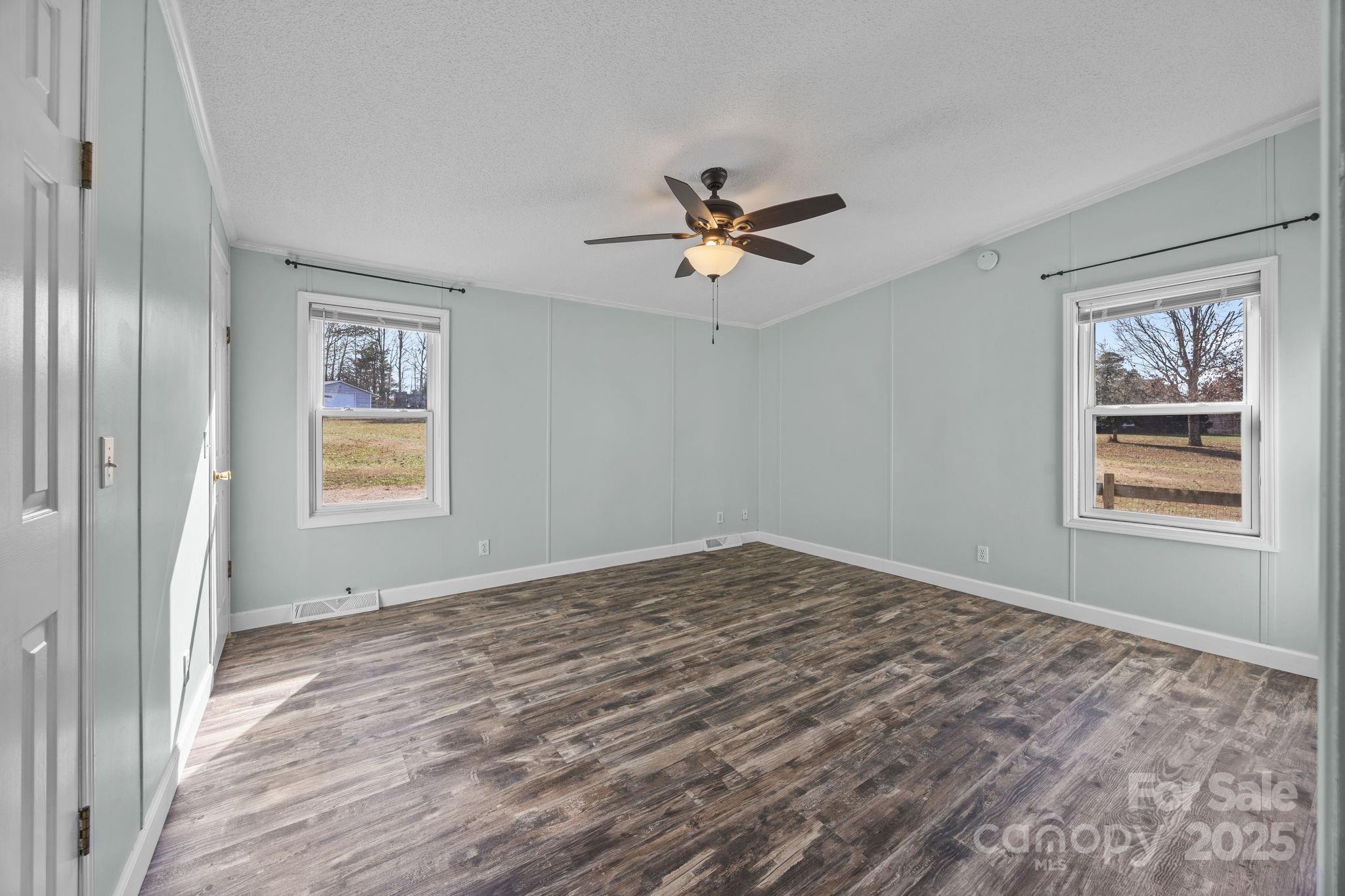 21465 Old Beatty Ford Road Richfield, NC 28137 - Photo 28 of 41 a view of empty room with wooden floor and fan