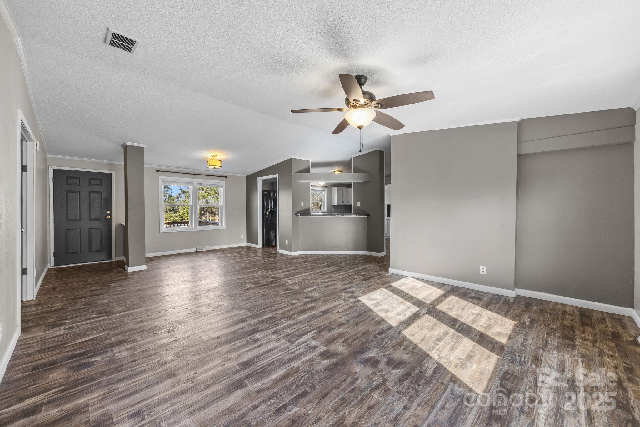 21465 Old Beatty Ford Road Richfield, NC 28137 - Photo 5 of 41 a view of an empty room with a window and wooden floor