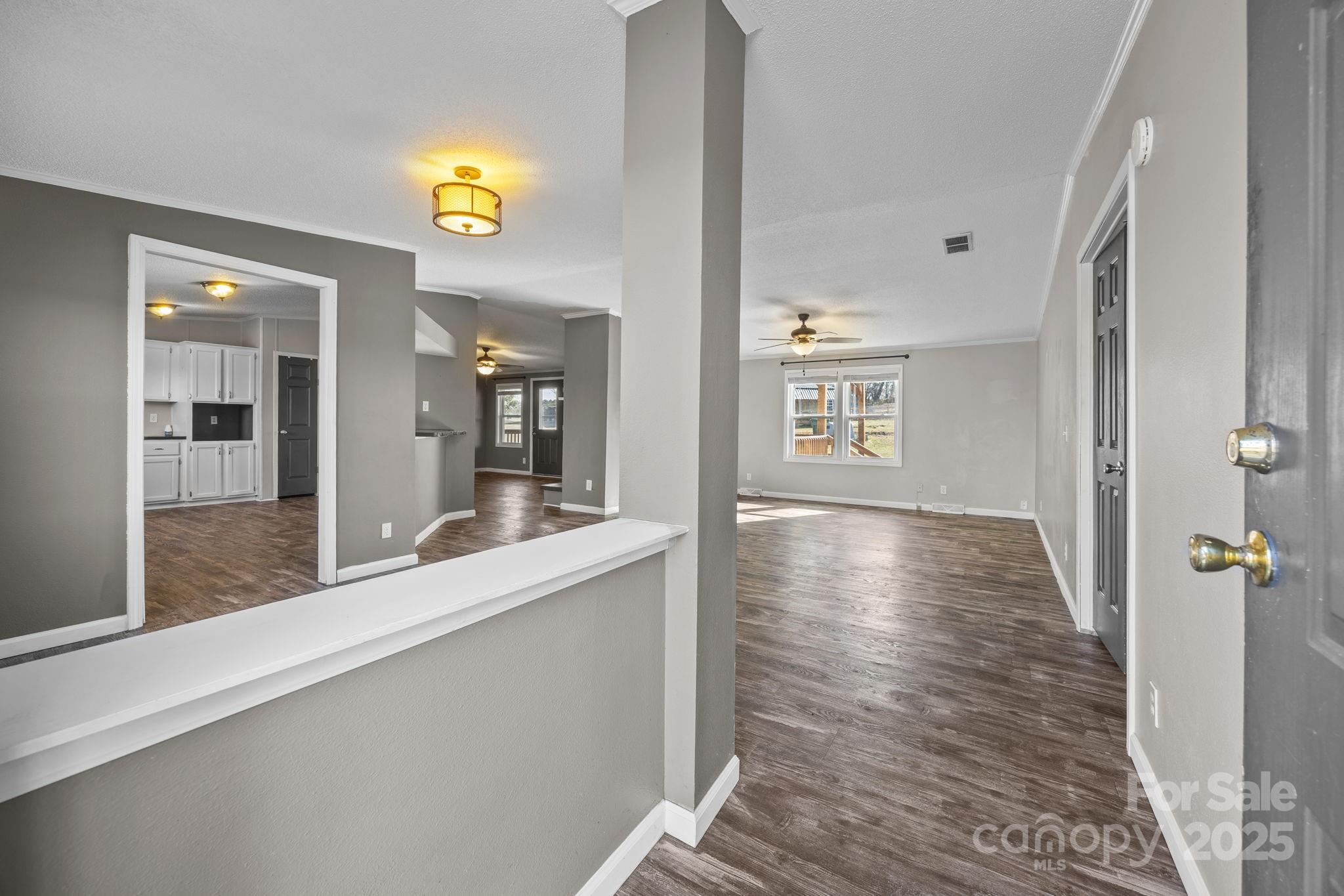 21465 Old Beatty Ford Road Richfield, NC 28137 - Photo 6 of 41 a view of a hallway with wooden floor and a bathroom