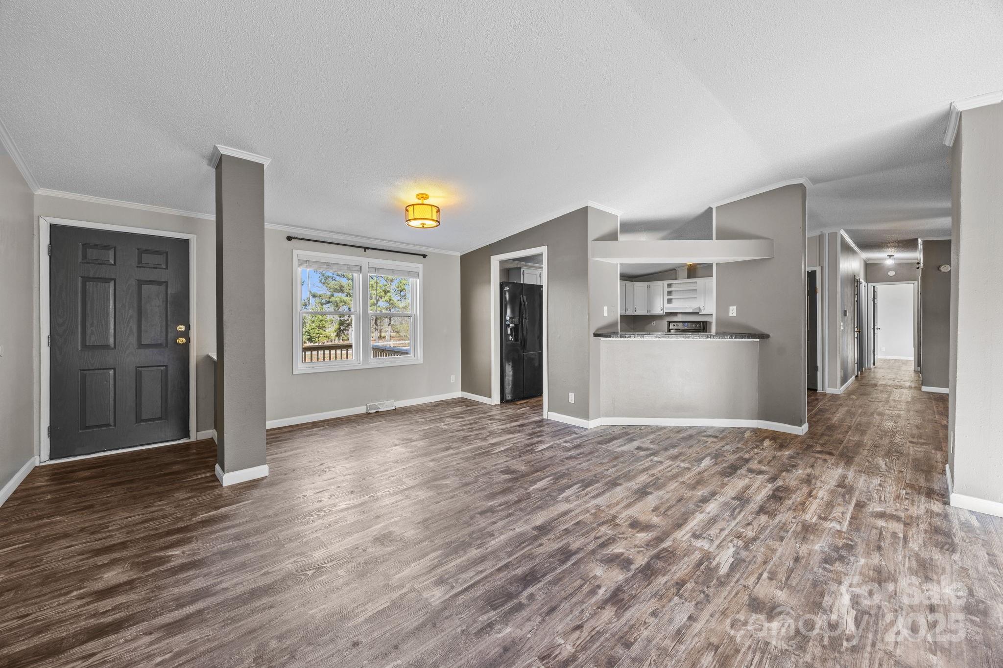 21465 Old Beatty Ford Road Richfield, NC 28137 - Photo 7 of 41 a view of a kitchen with wooden floor and a window