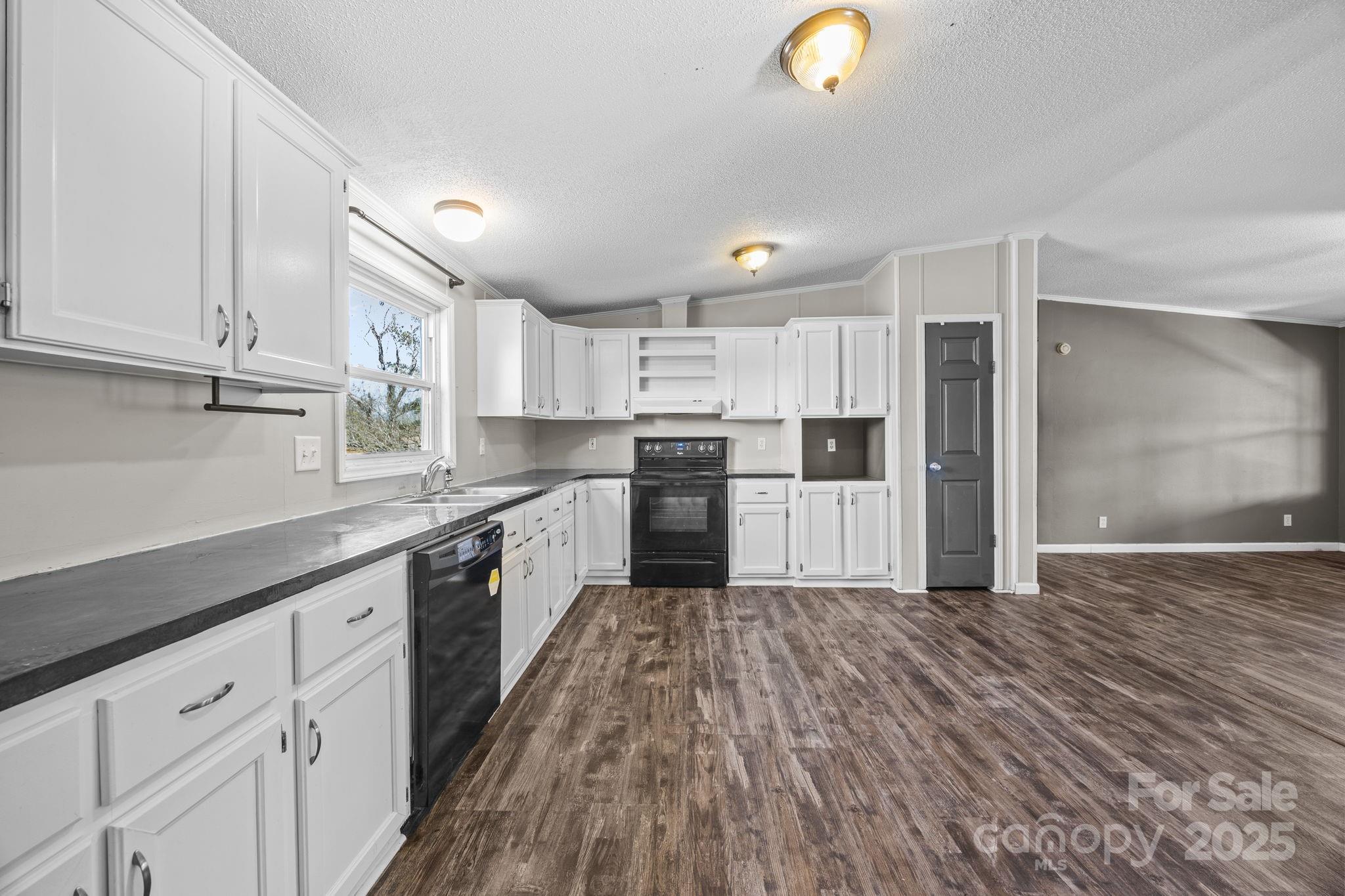 21465 Old Beatty Ford Road Richfield, NC 28137 - Photo 10 of 41 a large kitchen with cabinets and stainless steel appliances