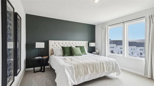 a bedroom with a large bed and a large window