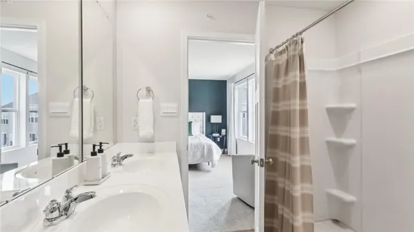 a en suite bathroom with a sink and mirror