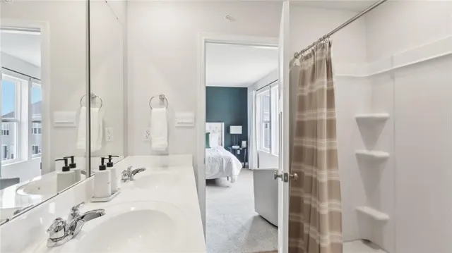 a en suite bathroom with a sink and mirror