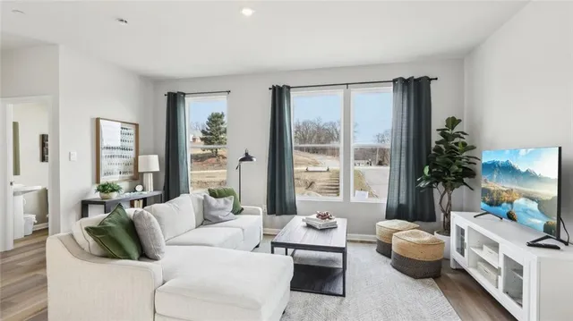 a living room with furniture and a large window