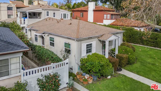 a aerial view of a house next to a yard