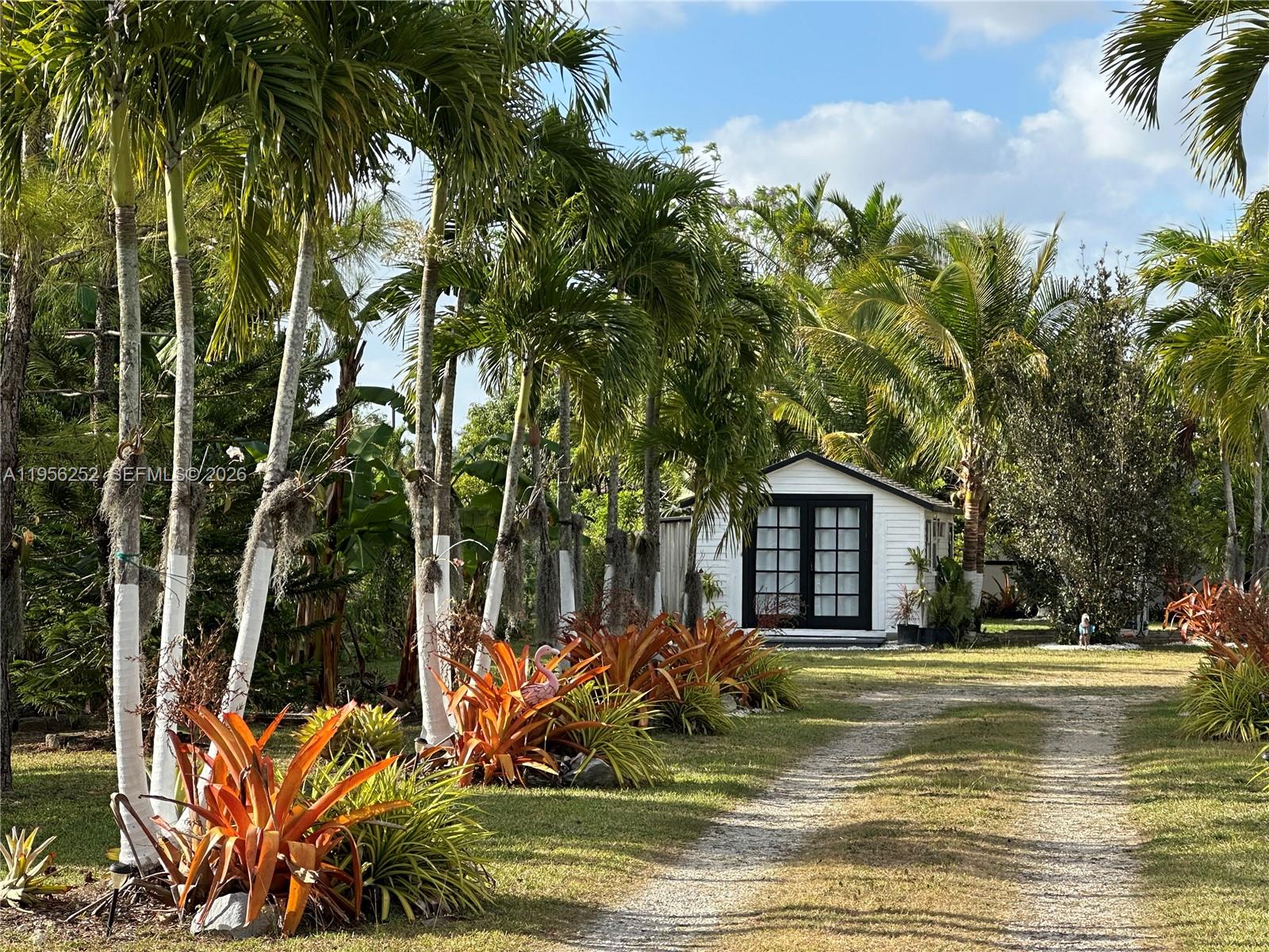 a view of a house with a small yard and sitting area