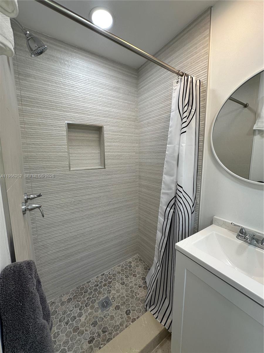 18481 Southwest 208th Street Miami, FL 33187 - Photo 5 of 17 a bathroom with a sink and a mirror