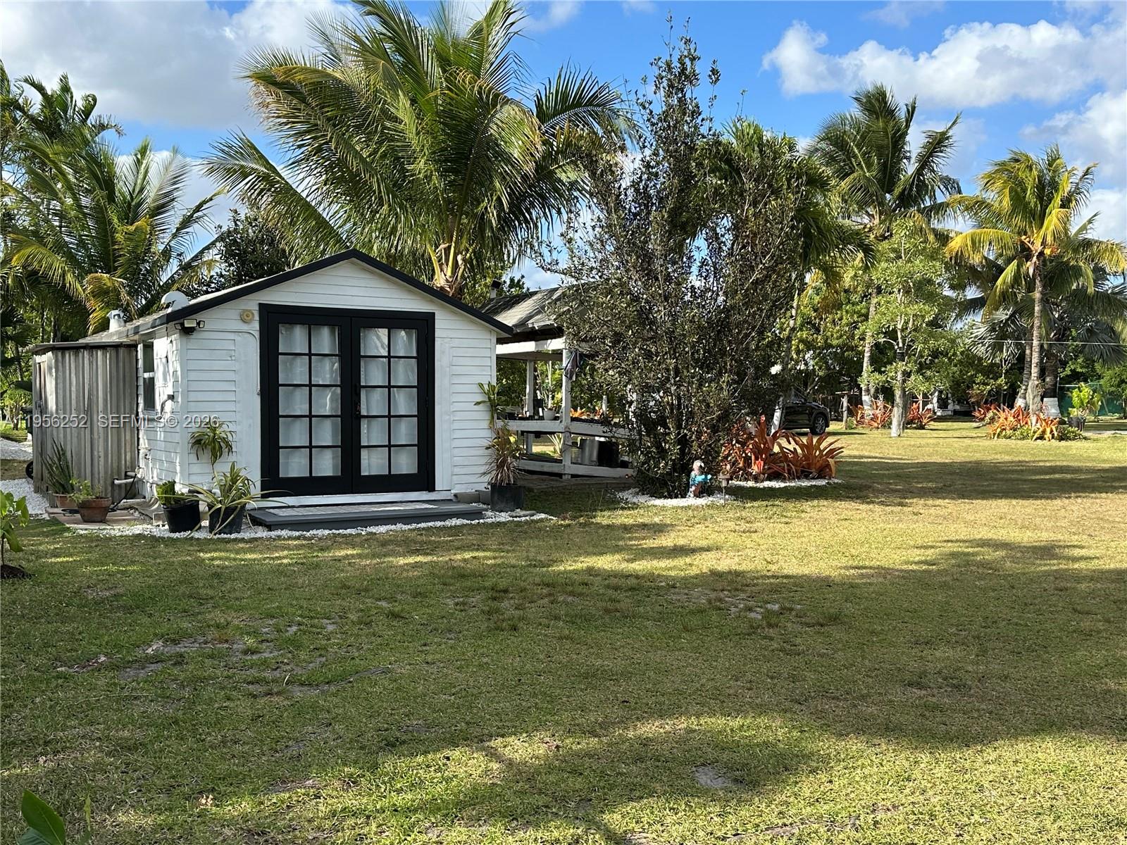 18481 Southwest 208th Street Miami, FL 33187 - Photo 10 of 17 a view of a house with a yard