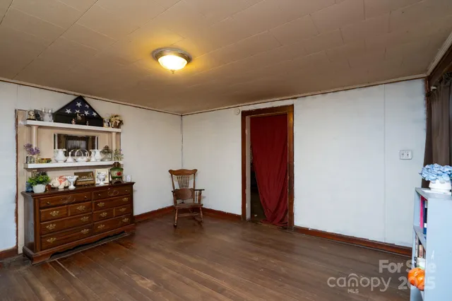 a view of a workspace with furniture and wooden floor