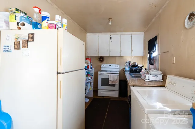 a white refrigerator freezer sitting inside of a kitchen