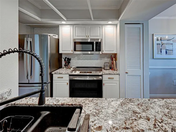 a kitchen with a sink stove and refrigerator