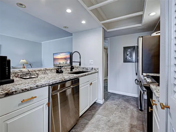 a kitchen with stainless steel appliances granite countertop a sink stove and cabinets