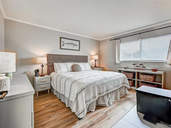 a bedroom with a bed and a night stand