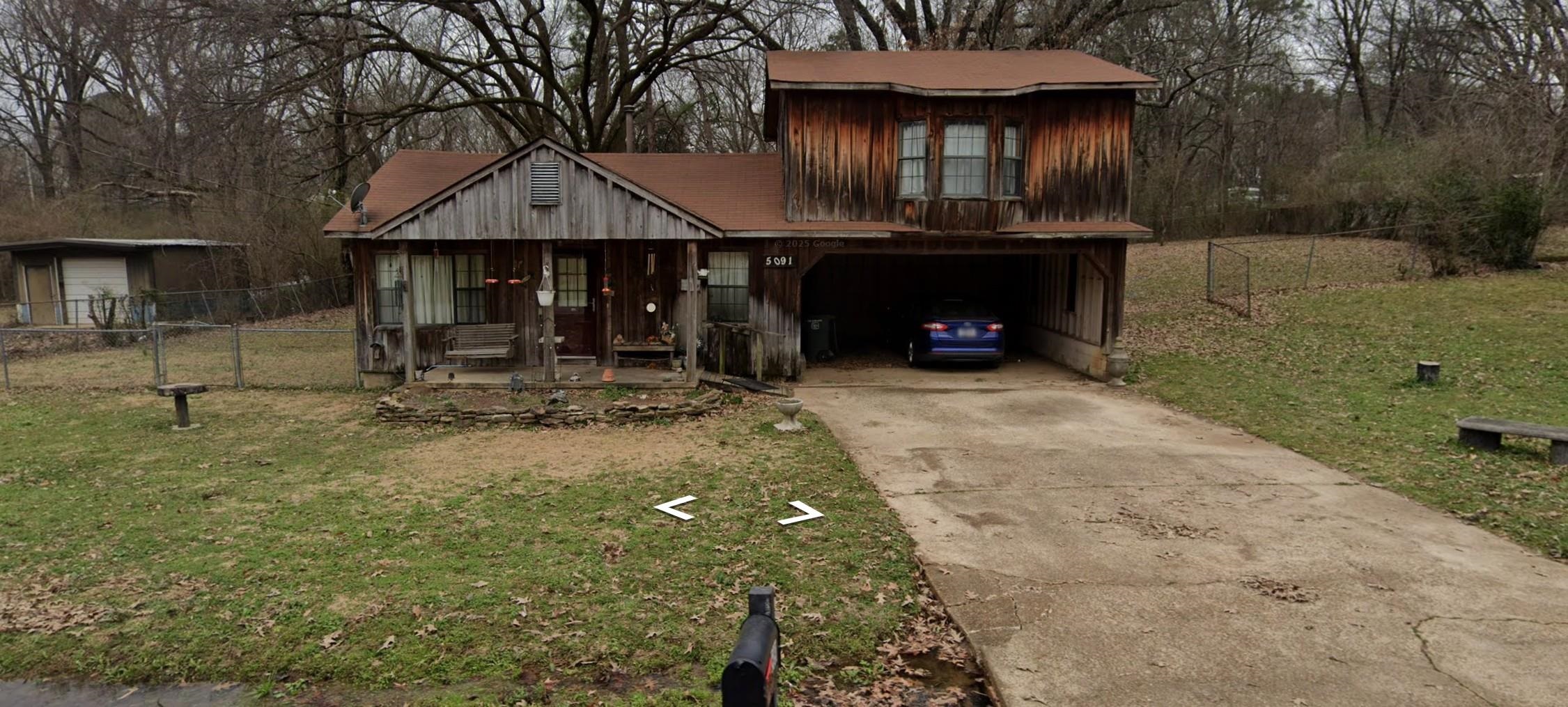 Chalet / cabin featuring concrete driveway, covered porch, and a garage