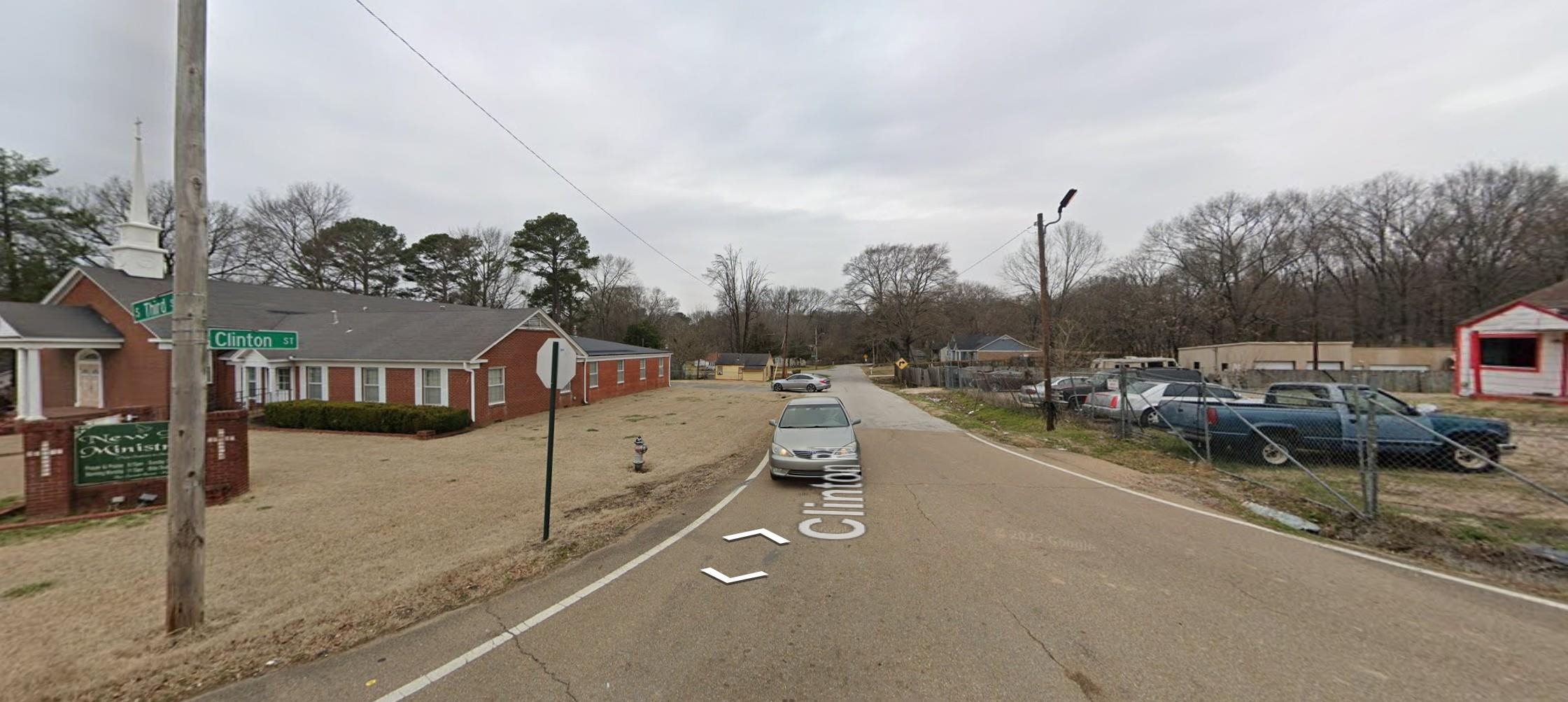 5091 Clinton Road Memphis, TN 38109 - Photo 8 of 12 View of asphalt road featuring traffic signs