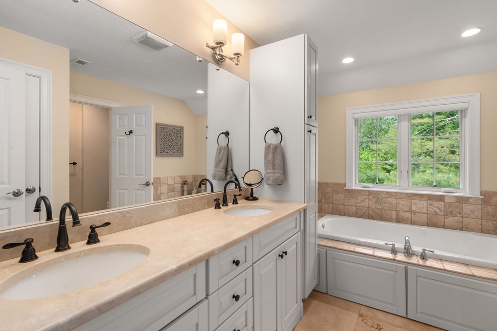 16 Winfield Street Needham, MA 02492 - Photo 18 of 42 a bathroom with a tub sink and mirror