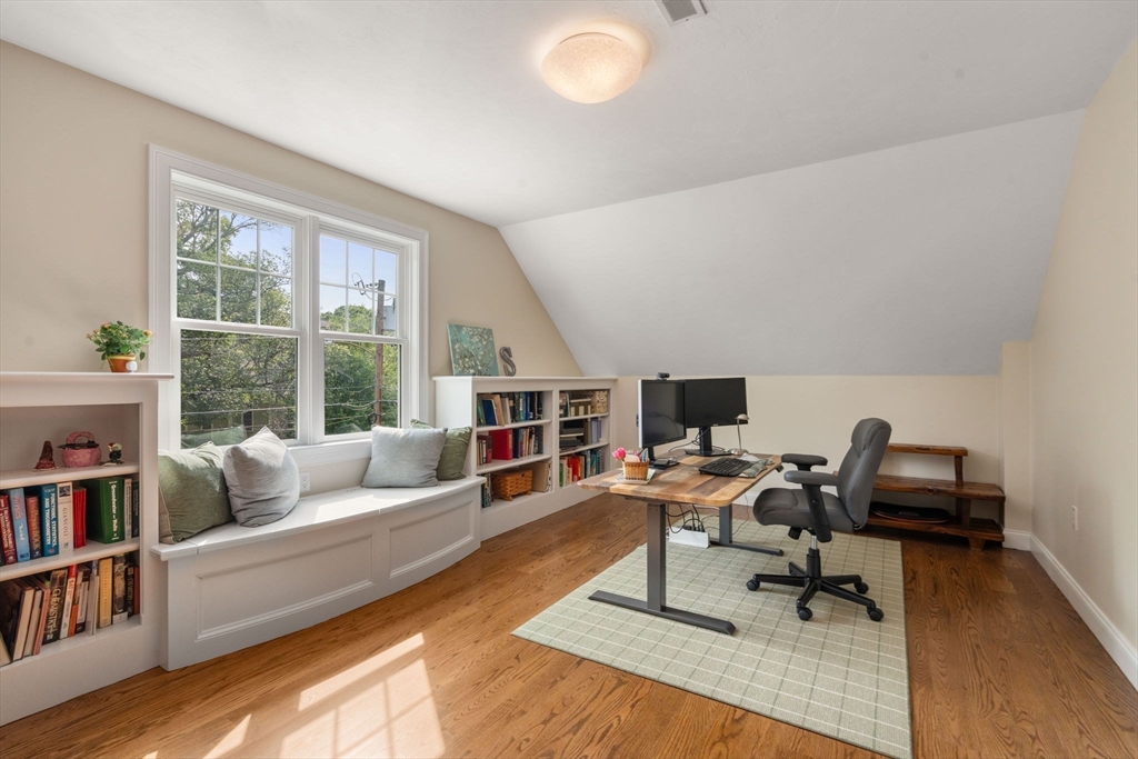 16 Winfield Street Needham, MA 02492 - Photo 21 of 42 a living room with furniture and a book shelf