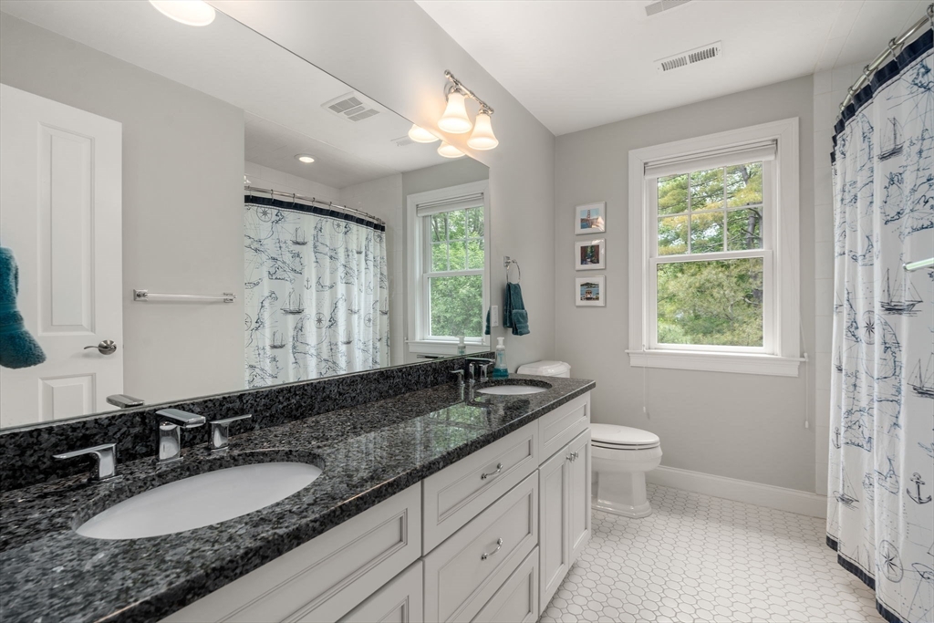 16 Winfield Street Needham, MA 02492 - Photo 25 of 42 a bathroom with a granite countertop double vanity and a mirror