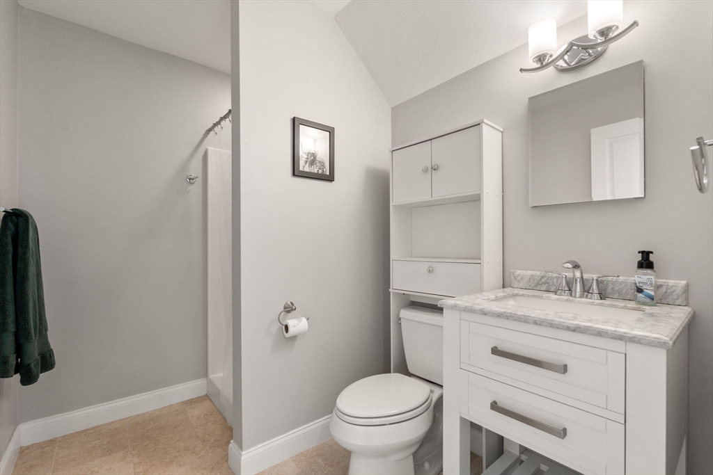 16 Winfield Street Needham, MA 02492 - Photo 26 of 42 a bathroom with a granite countertop sink toilet and mirror