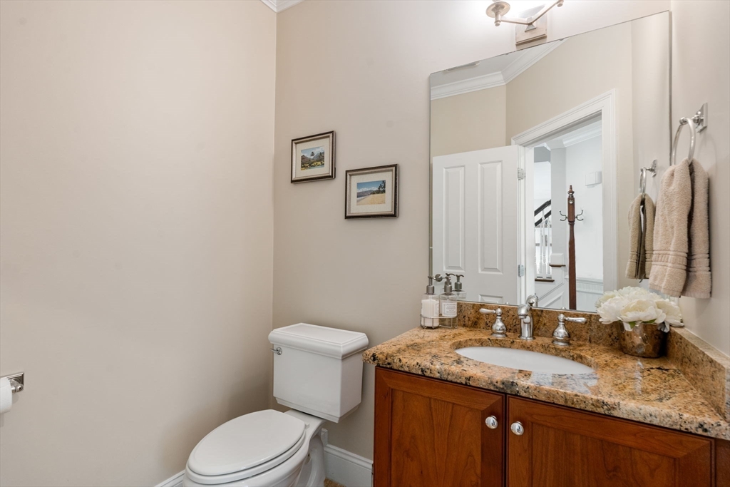 16 Winfield Street Needham, MA 02492 - Photo 31 of 42 a bathroom with a granite countertop sink toilet and mirror