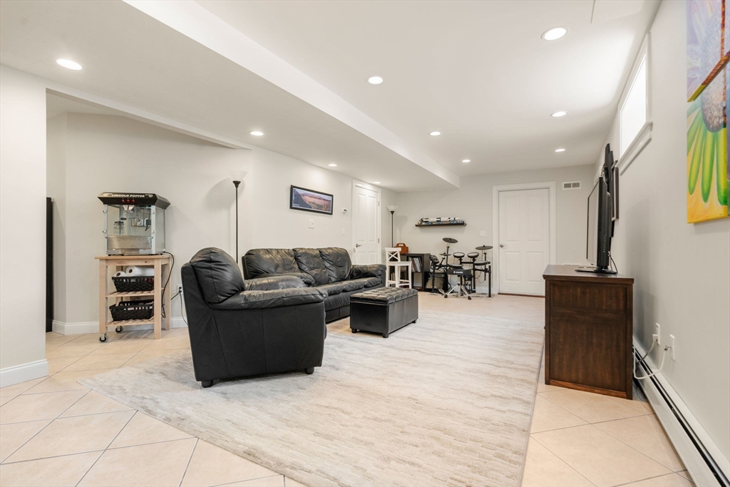 16 Winfield Street Needham, MA 02492 - Photo 33 of 42 a living room with furniture and a wooden floor