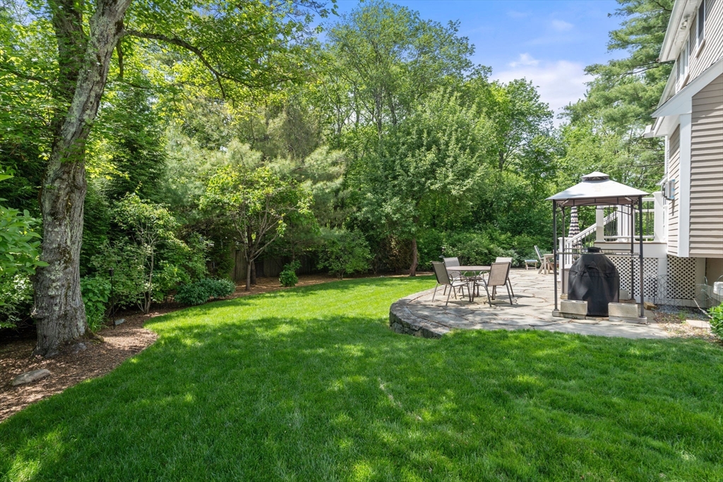 16 Winfield Street Needham, MA 02492 - Photo 37 of 42 a view of a chair and table with garden in the background