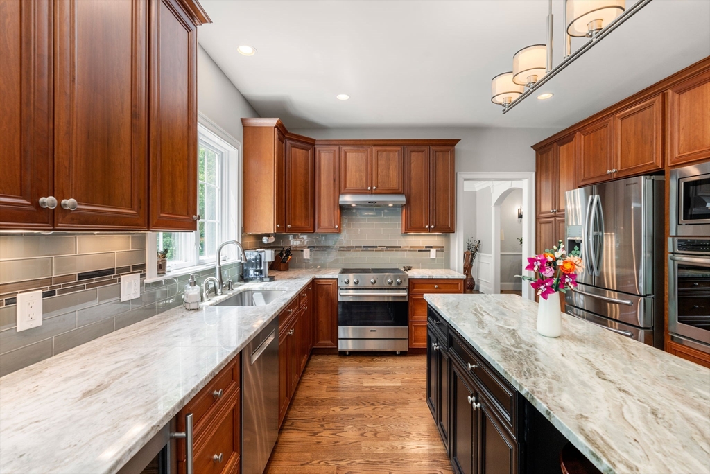 16 Winfield Street Needham, MA 02492 - Photo 8 of 42 a kitchen with stainless steel appliances a sink stove and refrigerator